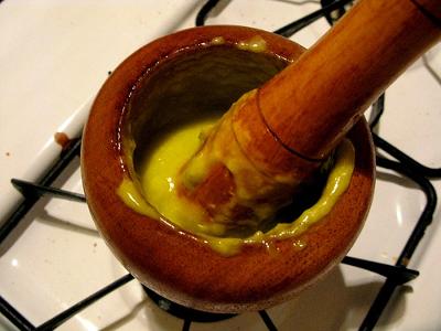 drizzle in the olive oil, drop by drop until it emulsifies into a paste